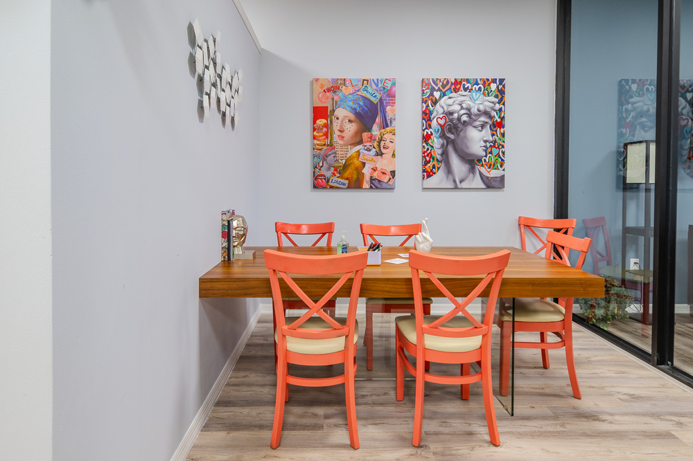 Kitchen and break area with orange chairs at Work Social