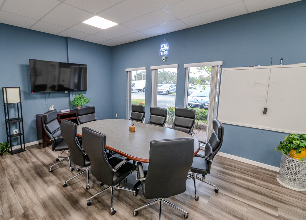 Conference room with a large table and TV screen at Work Social