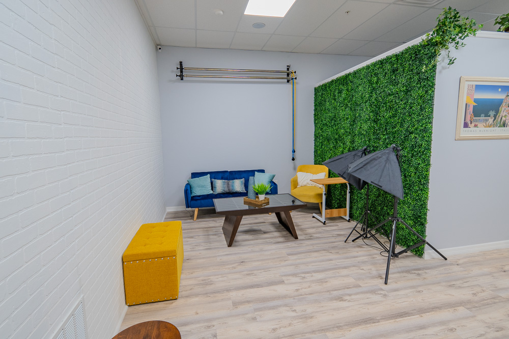 Studio corner with lights, backdrop and lounge seating at Work Social